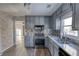 Renovated kitchen with gray cabinets, granite countertops, and stainless steel appliances at 758 Shoreline Se Trl, Conyers, GA 30094