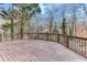 Spacious wooden deck with a wooden railing overlooking a wooded area at 2843 Merritt Dr, Buford, GA 30518