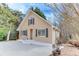 Tan house with gray roof, dark shutters, and a paved driveway at 2843 Merritt Dr, Buford, GA 30518