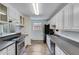 White kitchen with stainless steel appliances at 2843 Merritt Dr, Buford, GA 30518