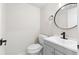 Modern powder room featuring a stylish vanity, round mirror, and matte black faucet at 1126 Williamsburg Ln, Norcross, GA 30093