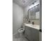 Renovated bathroom with gray vanity, modern fixtures, and stylish lighting at 1126 Williamsburg Ln, Norcross, GA 30093