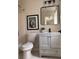 Updated bathroom featuring modern vanity, toilet, and decor at 1126 Williamsburg Ln, Norcross, GA 30093