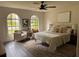Bright bedroom with neutral tones, stylish furniture, and arched windows at 1126 Williamsburg Ln, Norcross, GA 30093