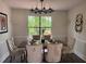 Dining room features a modern light fixture, elegant table setting and rear view at 1126 Williamsburg Ln, Norcross, GA 30093