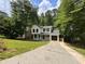 Charming two-story home with a manicured lawn, black windows, black door and an attached garage at 1126 Williamsburg Ln, Norcross, GA 30093