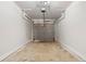 Empty garage with functional door mechanism and concrete floor at 1126 Williamsburg Ln, Norcross, GA 30093