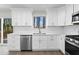 Newly renovated kitchen with white cabinets, stainless steel appliances, and backyard view at 1126 Williamsburg Ln, Norcross, GA 30093