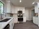 Modern kitchen features white cabinets, stainless steel appliances, and bright countertops at 1126 Williamsburg Ln, Norcross, GA 30093