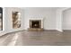 Bright living room with a stone fireplace, stylish flooring and large window overlooking the backyard at 1126 Williamsburg Ln, Norcross, GA 30093