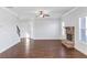 Living room with hardwood floors, fireplace, and ceiling fan at 149 Elkins Blvd, Locust Grove, GA 30248