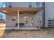 Covered patio with ceiling fan and seating area at 149 Elkins Blvd, Locust Grove, GA 30248