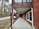 A covered patio with a ceiling fan and stairs leading to a backyard at 3648 Clark Hill Way, Buford, GA 30519