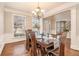 Elegant dining room with hardwood floors and a large window at 1525 Haddenham Dr, Cumming, GA 30041