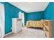 Bedroom with teal walls, dresser, and bookshelf at 1144 Kipling Se St, Atlanta, GA 30315