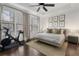 Spacious main bedroom with a king-size bed, exercise bike, and ample natural light at 1577 Aldworth Se Pl, Atlanta, GA 30339