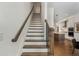 Modern staircase with dark wood railings and white risers leading to the upper level at 1577 Aldworth Se Pl, Atlanta, GA 30339