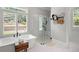 Spa-like bathroom with a walk-in shower, soaking tub, and modern fixtures at 2193 Bliss Ln, Marietta, GA 30062