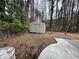 Backyard with storage shed, some foliage and a concrete patio at 22 Cardinal Ln, Jonesboro, GA 30238