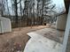 Spacious backyard featuring a concrete patio, mature trees, and storage shed at 22 Cardinal Ln, Jonesboro, GA 30238