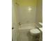 Bathroom with a white tiled shower/tub and marble countertop on a vanity with toilet at 22 Cardinal Ln, Jonesboro, GA 30238