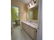 A bathroom vanity features marble countertop with a large mirror and modern lighting at 22 Cardinal Ln, Jonesboro, GA 30238