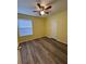 A bright bedroom offers hardwood floors and a ceiling fan with lights at 22 Cardinal Ln, Jonesboro, GA 30238