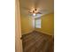 This bedroom has gray wood floors, a ceiling fan, a window with blinds and yellow walls at 22 Cardinal Ln, Jonesboro, GA 30238