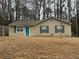 Charming single-story home with neutral siding, a well-maintained lawn, and a vibrant blue front door at 22 Cardinal Ln, Jonesboro, GA 30238