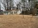 A single-story home with a nice yard, complemented by mature trees and a storage building at 22 Cardinal Ln, Jonesboro, GA 30238