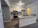 Stylish kitchen with stainless steel appliances, granite countertops, and warm wood-look flooring at 22 Cardinal Ln, Jonesboro, GA 30238