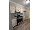 Well-appointed kitchen boasts granite countertops, new appliances, and lovely wood-look flooring at 22 Cardinal Ln, Jonesboro, GA 30238
