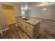 Kitchen featuring granite counters, cabinets, wood-look flooring, and open view to the living area at 22 Cardinal Ln, Jonesboro, GA 30238