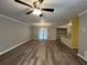 Inviting living room features modern flooring, ceiling fan, and seamlessly connects to the dining area and kitchen at 22 Cardinal Ln, Jonesboro, GA 30238