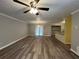 Inviting living room with a ceiling fan, wood-look floors, and access to the kitchen at 22 Cardinal Ln, Jonesboro, GA 30238