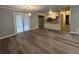 Inviting living room features modern flooring, a chandelier, and seamlessly connects to the dining area and kitchen at 22 Cardinal Ln, Jonesboro, GA 30238
