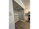 Pantry in the kitchen with shelves, cabinets, and laminate flooring at 22 Cardinal Ln, Jonesboro, GA 30238