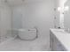 Bathroom with freestanding tub, shower, and marble floor at 1072 Green St, Roswell, GA 30075