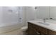 Clean bathroom with single vanity, tub, and shower at 1072 Green St, Roswell, GA 30075