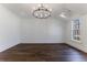 Spacious bedroom with dark hardwood floors and a chandelier at 1072 Green St, Roswell, GA 30075