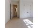 Well-lit bedroom with carpet flooring and access to a bathroom at 1072 Green St, Roswell, GA 30075