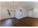 Bright dining room with dark hardwood floors, a modern chandelier and natural light from windows at 1072 Green St, Roswell, GA 30075