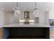 Modern kitchen island with white quartz countertops and dark cabinetry at 1072 Green St, Roswell, GA 30075