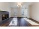 Spacious living room with hardwood floors and a modern fireplace at 1072 Green St, Roswell, GA 30075