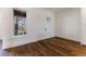 Bright room with hardwood floors, large windows, and trim accents at 1072 Green St, Roswell, GA 30075