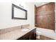 Bathroom with granite vanity, tiled shower, and updated fixtures at 333 Nelson Sw St # 404, Atlanta, GA 30313