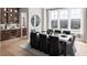 Elegant dining room with large windows, hardwood floors and a modern chandelier at 2726 Thornwilde Se Ln, Vinings, GA 30339