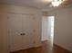 Bedroom with hardwood floors, double door closet and access to another room at 3952 Creel Dr, Lithia Springs, GA 30122