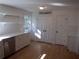 Modern kitchen with white cabinets and hardwood floors at 3952 Creel Dr, Lithia Springs, GA 30122