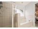 Bathroom with shower, bathtub, and window at 439 Mountain View Ln, Woodstock, GA 30188